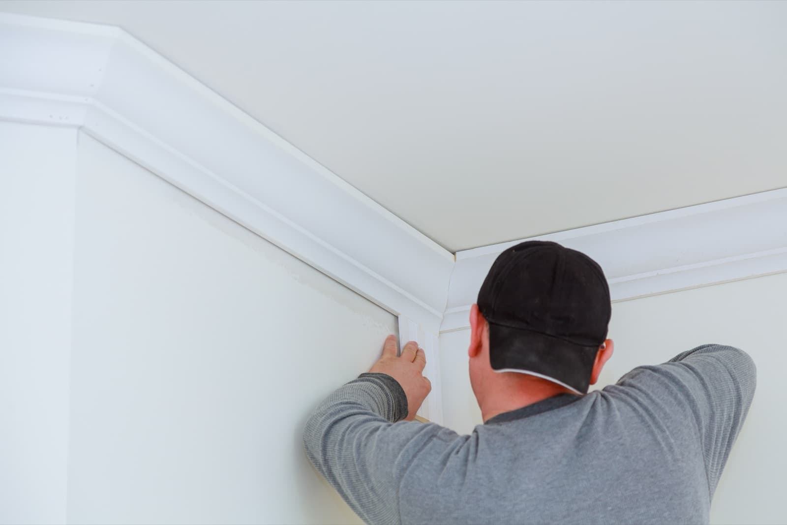 Finish carpenter installing crown molding in a residential home