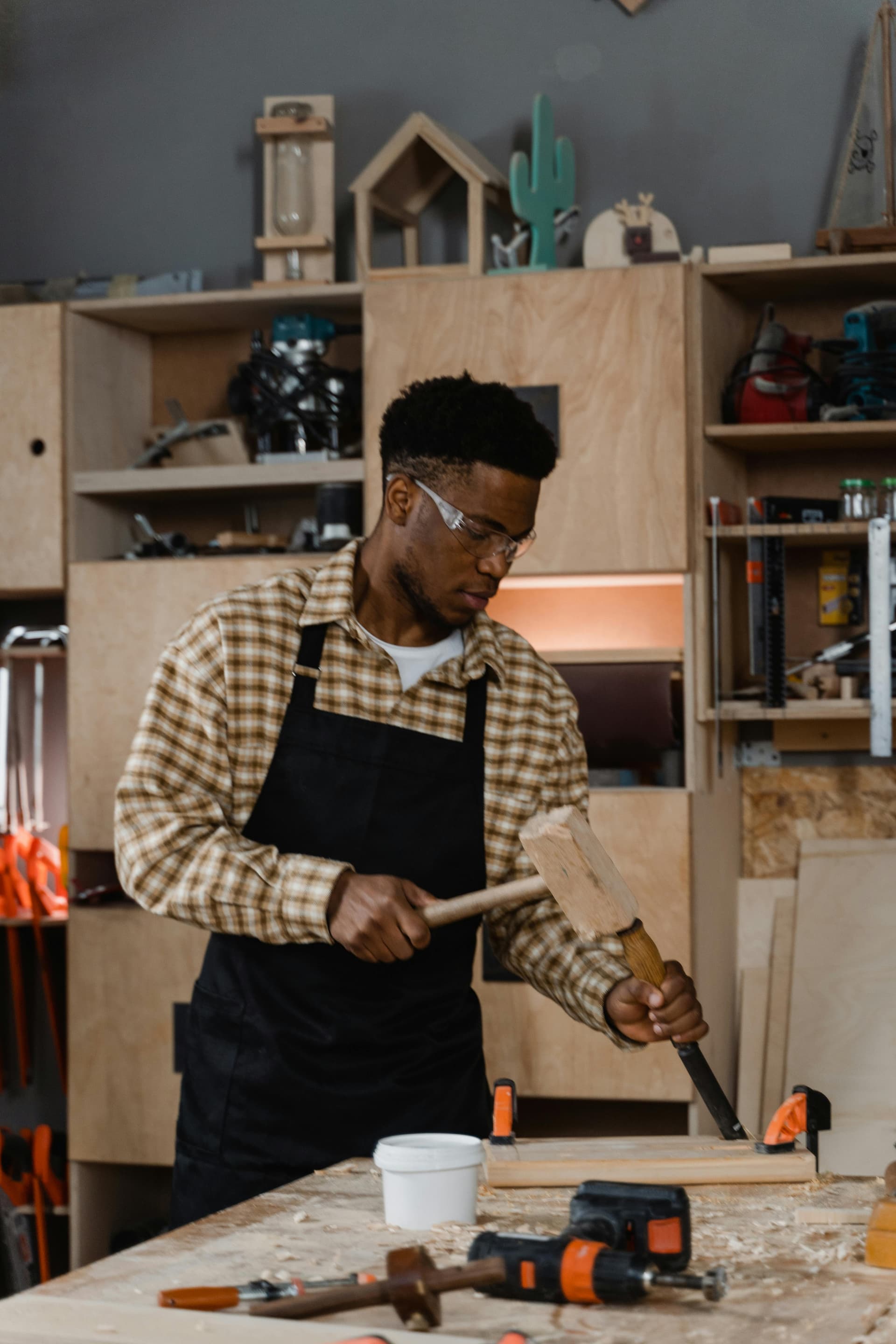 Craftsman working with a chisel in a woodworking shop